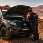 Entretien Nissan Navara Djibouti — technicien ACRIES révisant un pick-up Nissan sur piste volcanique